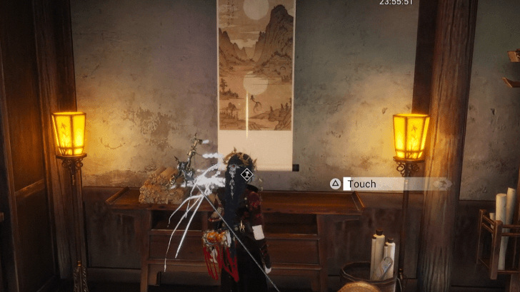 Touch the scroll between the two wall lamps.